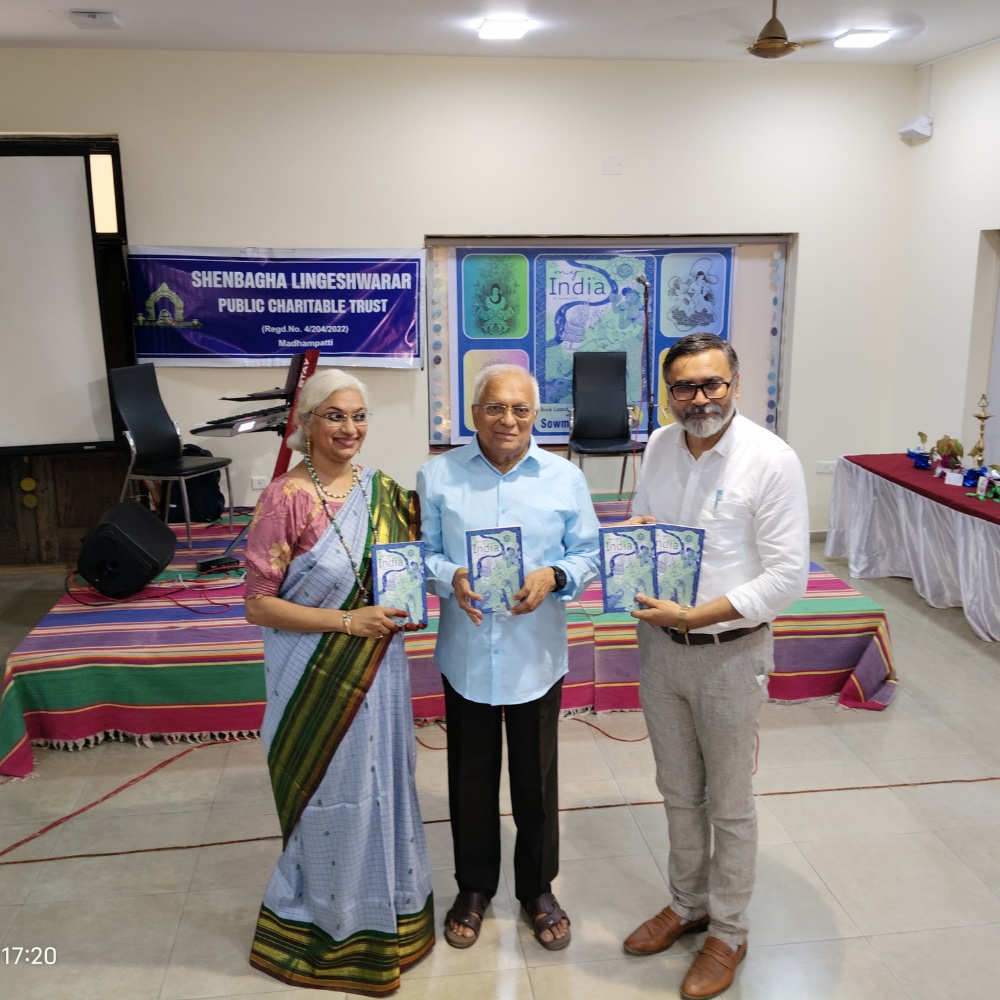 Three guests holding copies of My India at a community launch event